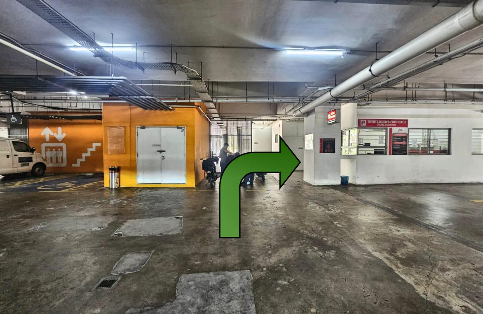 The orange lift and management office in the LG1 car park: walk straight to them, then turn right